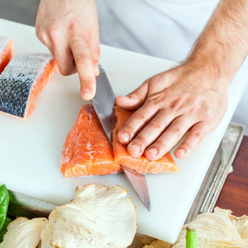 Image of someone cutting salmon